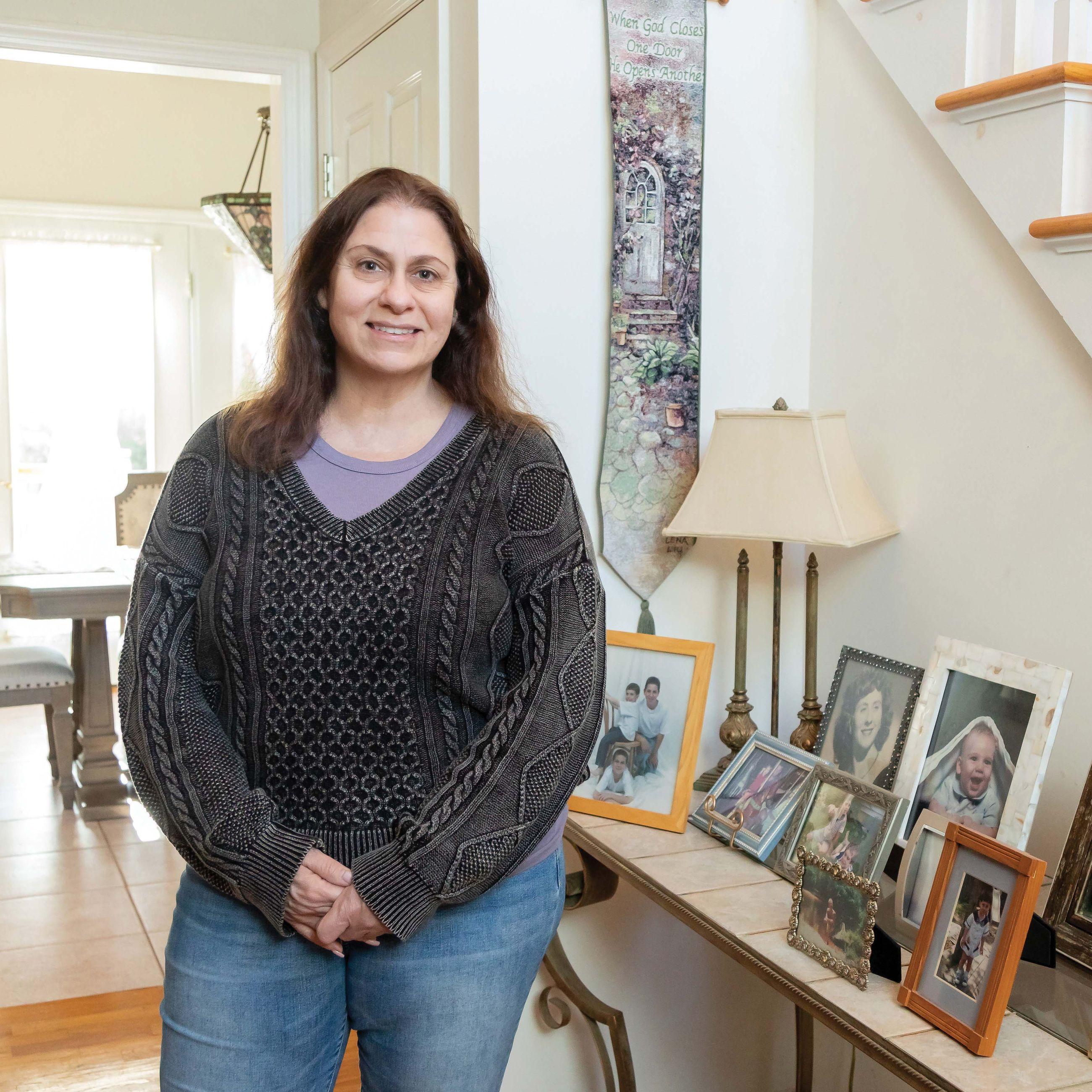 Deborah standing in the entrance of her home