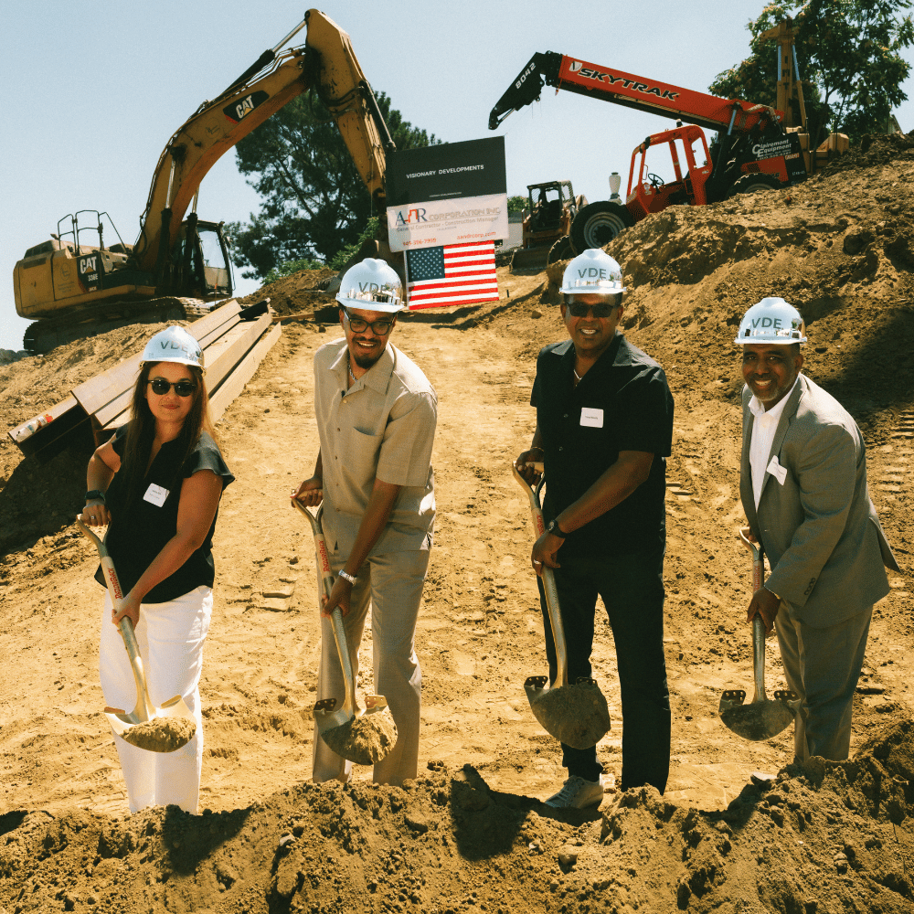 Galina Kim (left), VP of Closings and Construction Loan Management at BlueHub Loan Fund, joined Terry Harris (center left) and other partners to celebrate The Court Residences’ groundbreaking.