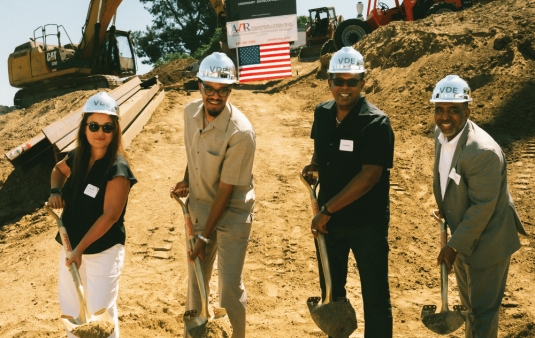 Galina Kim (left), VP of Closings and Construction Loan Management at BlueHub Loan Fund, joined Terry Harris (center left) and other partners to celebrate The Court Residences’ groundbreaking.
