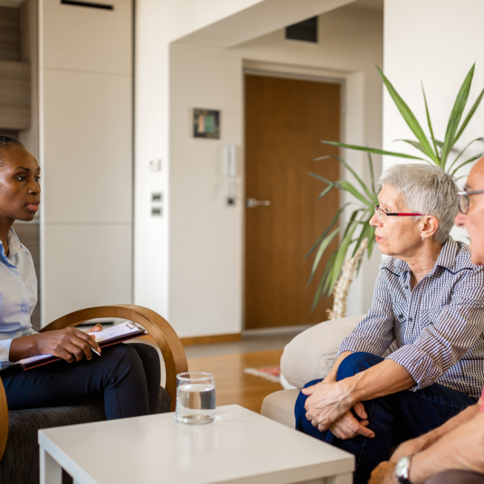 Elder couple speaking with housing counselor