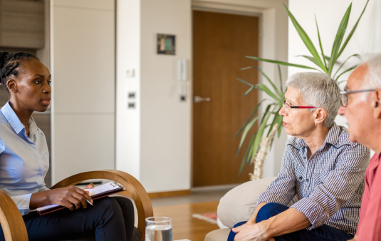 Elder couple speaking with housing counselor